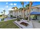 Exterior view of building with colorful landscaping, palm trees, and well-kept grounds at 237 Blackburn Blvd, North Port, FL 34287