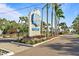 Welcome to Harbor Cove, a waterfront community marked by a distinguished sign and palm-lined street at 237 Blackburn Blvd, North Port, FL 34287