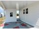 An exterior view of the property showing the carport with red and gray painted floor at 237 Blackburn Blvd, North Port, FL 34287