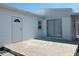 Exterior side of the house with a back door, slider door, and concrete patio at 237 Blackburn Blvd, North Port, FL 34287
