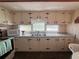 Functional kitchen with white cabinets, and a stainless steel sink at 237 Blackburn Blvd, North Port, FL 34287