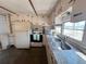 Cozy kitchen featuring white cabinets, a stainless steel sink, and standard appliances at 237 Blackburn Blvd, North Port, FL 34287
