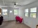 Bright living room with multiple windows, a ceiling fan, and a neutral color palette at 237 Blackburn Blvd, North Port, FL 34287