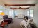 Inviting living room with exposed beams, neutral tones, and plenty of natural light at 237 Blackburn Blvd, North Port, FL 34287