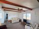 Cozy living room featuring exposed wood beams, carpeted floors, and an efficient ceiling fan at 237 Blackburn Blvd, North Port, FL 34287