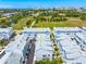 An aerial view of the townhome community near a park and a downtown skyline, offering the best of city and nature at 2408 Ezzell Ct, Sarasota, FL 34237