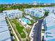 Aerial view of a community featuring a pool, putting green, and well-maintained townhomes at 2408 Ezzell Ct, Sarasota, FL 34237
