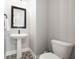 Powder room with pedestal sink, decorative tile and modern fixtures at 2408 Ezzell Ct, Sarasota, FL 34237