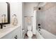 Bathroom with tile shower and tub, white vanity, and neutral tile floor at 2408 Ezzell Ct, Sarasota, FL 34237