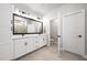 Bright bathroom features double vanity with large mirror and neutral tile flooring at 2408 Ezzell Ct, Sarasota, FL 34237