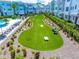 Well-manicured common area featuring a putting green, cornhole boards, and seating for residents to enjoy at 2408 Ezzell Ct, Sarasota, FL 34237