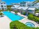 Resort-style pool and hot tub with blue lounge chairs surrounded by beautiful landscaping at this townhome community at 2408 Ezzell Ct, Sarasota, FL 34237