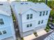 Three-story townhome with garages and modern architecture, creating a stylish and functional living space at 2408 Ezzell Ct, Sarasota, FL 34237