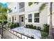 Townhome with a well-manicured front yard, walkway, and black wrought iron fence at 2408 Ezzell Ct, Sarasota, FL 34237
