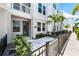 Townhome with a tiled front patio, walkway, and lush landscaping at 2408 Ezzell Ct, Sarasota, FL 34237
