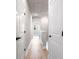 Well-lit hallway with wood floors and white doors, showcasing the home's clean design at 2408 Ezzell Ct, Sarasota, FL 34237