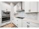 Well-equipped kitchen with stainless steel appliances, white cabinetry, and sleek countertops at 2408 Ezzell Ct, Sarasota, FL 34237
