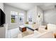 Inviting living room with cozy seating, modern decor, and abundant natural light from large windows at 2408 Ezzell Ct, Sarasota, FL 34237
