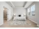 Bright bedroom featuring tray ceiling, ensuite bath, and large windows at 2408 Ezzell Ct, Sarasota, FL 34237