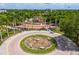 Aerial view of a colorful playground in Payne Park, surrounded by palm trees and greenery at 2408 Ezzell Ct, Sarasota, FL 34237