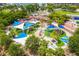 The playground with colorful sunshades offers a safe and fun play area, surrounded by lush greenery at 2408 Ezzell Ct, Sarasota, FL 34237