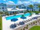 Inviting community pool with sun loungers and modern townhomes, perfect for relaxation and social gatherings at 2408 Ezzell Ct, Sarasota, FL 34237