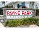 Elegant community signage for Payne Park Village amidst lush greenery and stone accents, conveying exclusivity at 2408 Ezzell Ct, Sarasota, FL 34237