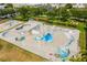 Aerial view of a skate park with various ramps, bowls, and graffiti art for skateboarders at 2408 Ezzell Ct, Sarasota, FL 34237