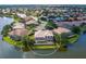 Expansive aerial view showcases the home's pool and serene lakefront setting at 2496 Farms Ct, Sarasota, FL 34240