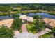 Aerial view of the property showcasing landscaping, brick driveway, and surrounding neighborhood at 2496 Farms Ct, Sarasota, FL 34240