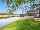 A lush backyard gently sloping down to a picturesque pond at 2496 Farms Ct, Sarasota, FL 34240