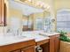 Bathroom with double sinks, stone countertops, and a large mirror at 2496 Farms Ct, Sarasota, FL 34240