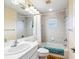 Bright bathroom with tiled shower and tub combo, large mirror, and white vanity at 2496 Farms Ct, Sarasota, FL 34240