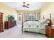 Bright bedroom with a four-poster bed, ceiling fan, and a view of the outdoors at 2496 Farms Ct, Sarasota, FL 34240