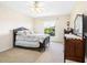 Well-lit bedroom featuring a classic bed frame, dresser, and large window with outdoor views at 2496 Farms Ct, Sarasota, FL 34240