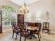 Formal dining room features hardwood floors, natural lighting, and traditional furnishings at 2496 Farms Ct, Sarasota, FL 34240