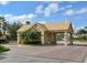 Charming gated community entrance with brick-paved road and lush tropical landscaping at 2496 Farms Ct, Sarasota, FL 34240