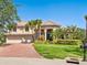 Charming two-story home boasts a manicured lawn and a convenient two-car garage at 2496 Farms Ct, Sarasota, FL 34240