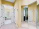 Hallway featuring an open doorway to the bathroom with tub and tile surround at 2496 Farms Ct, Sarasota, FL 34240