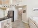 Bright kitchen features stainless steel appliances, modern countertops and accents, with stairs in background at 2496 Farms Ct, Sarasota, FL 34240