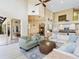 Bright living room with soaring ceilings, stylish furnishings, and an open floor plan to the kitchen and outdoor space at 2496 Farms Ct, Sarasota, FL 34240