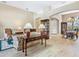 Bright and airy living room with neutral walls, ceiling beams, and a view to the dining area at 2496 Farms Ct, Sarasota, FL 34240