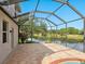 Covered patio overlooking a tranquil lake, providing a peaceful outdoor space for relaxation at 2496 Farms Ct, Sarasota, FL 34240