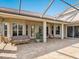Covered patio with seating area offering a relaxing outdoor space with a tile roof at 2496 Farms Ct, Sarasota, FL 34240