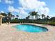 Beautiful community pool with ample deck space, stainless steel railings, and clear blue water at 2496 Farms Ct, Sarasota, FL 34240