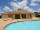 A refreshing community pool, surrounded by a spacious patio, lounge chairs and shaded seating areas at 2496 Farms Ct, Sarasota, FL 34240