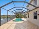 A screened patio with a pool and view of the lake at 2496 Farms Ct, Sarasota, FL 34240
