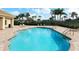 Beautiful community pool with ample deck space, stainless steel railings, and clear blue water at 2496 Farms Ct, Sarasota, FL 34240