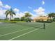 Well-maintained tennis court with lush greenery and a view of the surrounding community at 2496 Farms Ct, Sarasota, FL 34240
