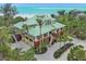 Spacious beachfront property showcasing a luxurious home, expansive parking, and lush landscaping at 26 Sandy Hook S Rd, Sarasota, FL 34242